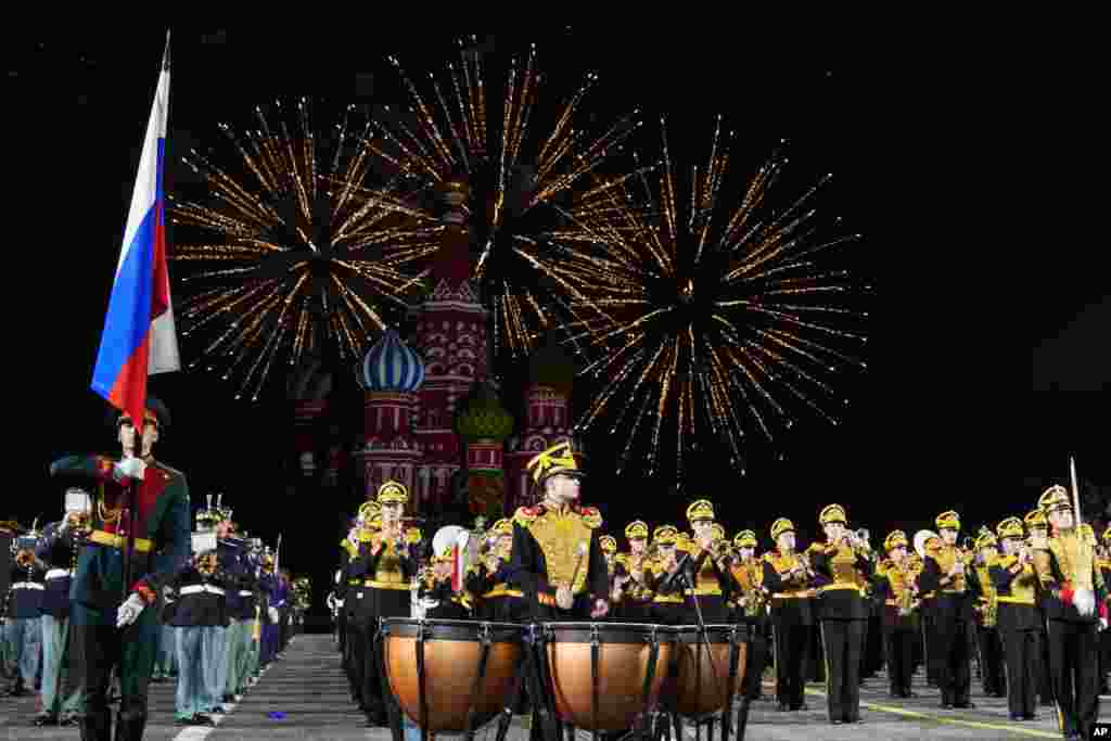 Fireworks explode as a combined military band of the participating countries performs during the Spasskaya Tower International Military Music Festival in Red Square, with the St. Basil Cathedral in the background, in Moscow, Russia, Aug. 31, 2021