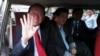 Cambodia's opposition leader Kem Sokha greets to the media after the court hearing in Phnom Penh, Wednesday, Jan. 15, 2020. (AP Photo/Heng Sinith)