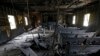 FILE - Burned pews and destroyed musical instruments, Bibles and hymnals are part of the debris inside the fire-damaged Hopewell M.B. Baptist Church in Greenville, Mississippi, Nov. 2, 2016. 