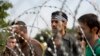Confusion rampant among migrants who got to the Hungarian border from Serbia, only to find a four-meter-high fence blocking their way, Sept. 15, 2015. (VOA /A. Tanzeem)