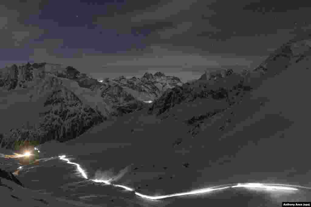 Competitors climb on their way to the 'Col De Riedmatten' pass and 'Col De Tsena Refien' pass, during the Glacier Patrol race near Arolla, Switzerland, 20 April 2016.
