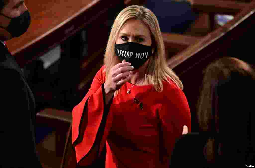 U.S. Rep. Marjorie Taylor Greene (R-GA) wears a &quot;Trump Won&quot; face mask as she arrives on the floor of the House to take her oath of office as a newly elected member of the 117th House of Representatives in Washington, D.C. Jan. 3, 2021.
