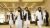 FILE - Afghanistan's Taliban delegation arrive for the agreement signing between Taliban and U.S. officials in Doha, Qatar, Feb. 29, 2020.